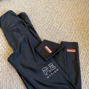 Pe nation solid black high rise legging ..pe nation logo on front and small stri
